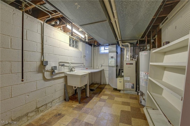 below grade area featuring gas water heater, heating unit, tile patterned floors, and a sink