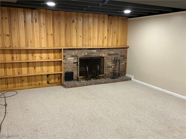 unfurnished living room featuring a fireplace, baseboards, and carpet floors