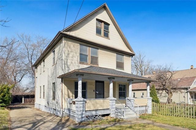 traditional style home featuring crawl space, covered porch, and fence