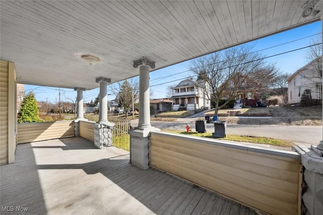 wooden deck featuring a residential view and a porch