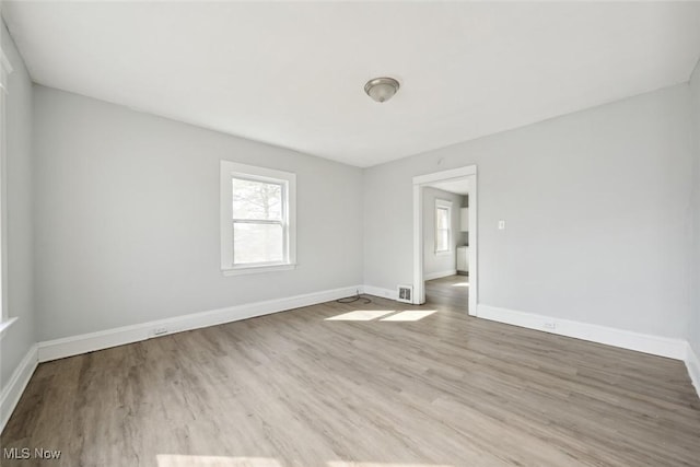 spare room featuring wood finished floors and baseboards