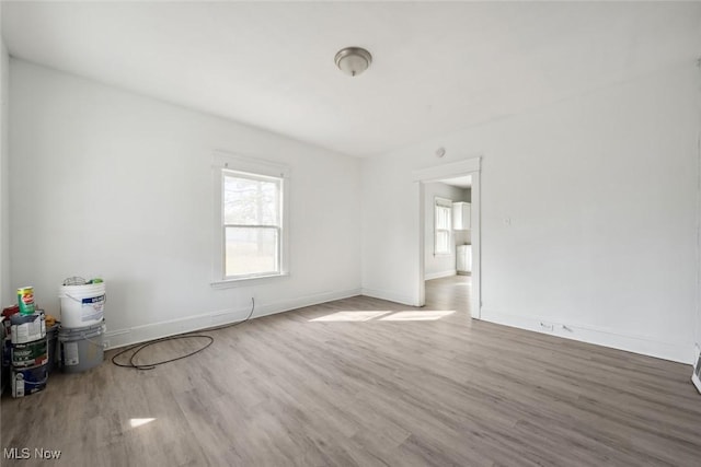 spare room with wood finished floors and baseboards