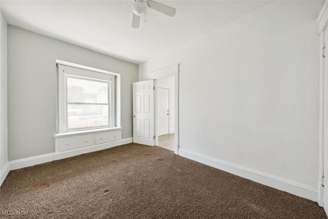 unfurnished bedroom with ceiling fan, baseboards, and carpet floors