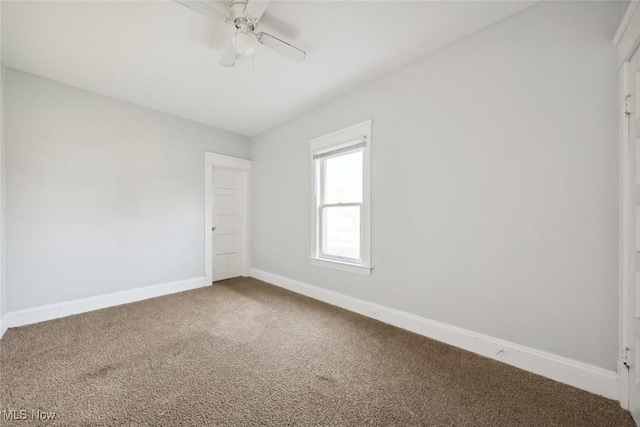 spare room featuring baseboards, carpet floors, and ceiling fan