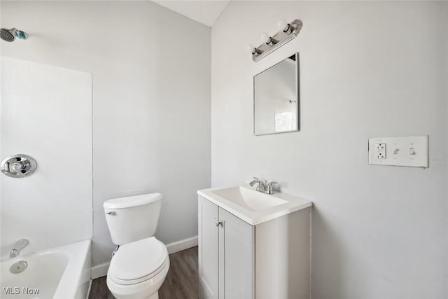 full bath featuring vanity, wood finished floors, baseboards,  shower combination, and toilet