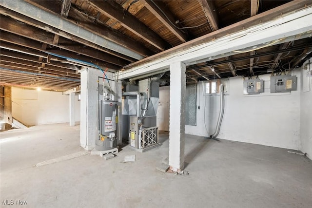 basement featuring water heater, heating unit, and electric panel