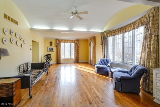 sitting room featuring visible vents, lofted ceiling, ceiling fan, and wood finished floors