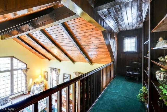 hall featuring wooden ceiling, vaulted ceiling with beams, and carpet