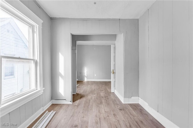 hall featuring baseboards and wood finished floors