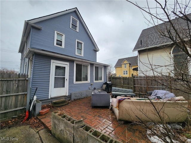 rear view of house featuring a patio, a fenced backyard, and entry steps