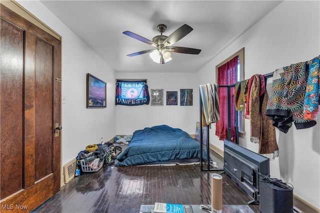 bedroom with hardwood / wood-style floors and a ceiling fan