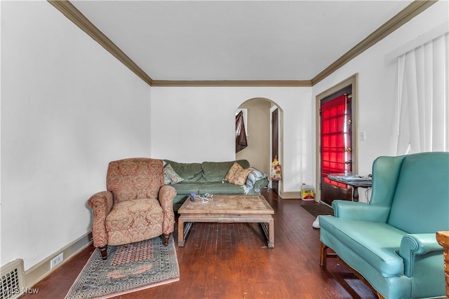 living room with baseboards, arched walkways, wood finished floors, and crown molding