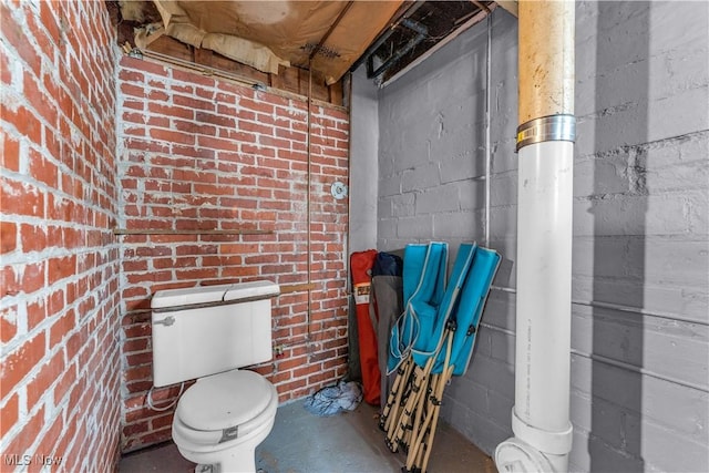 bathroom with toilet and concrete floors