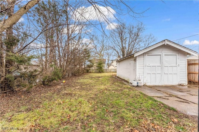 view of yard featuring an outdoor structure and fence