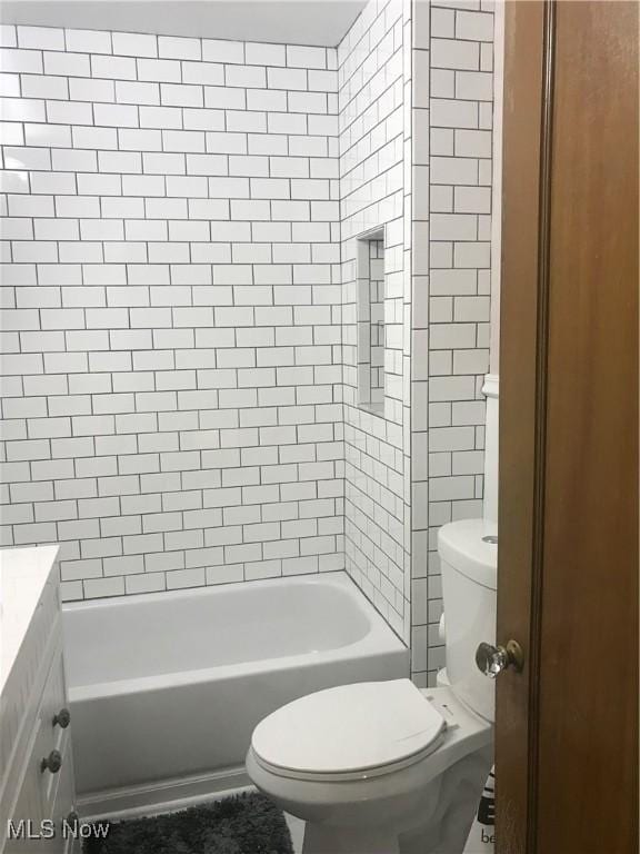 full bath with vanity, toilet, and bathing tub / shower combination