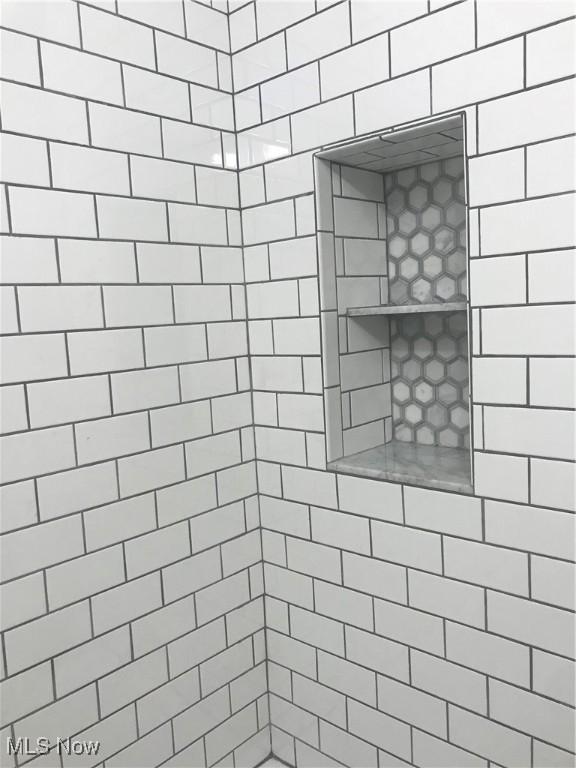 bathroom with tiled shower