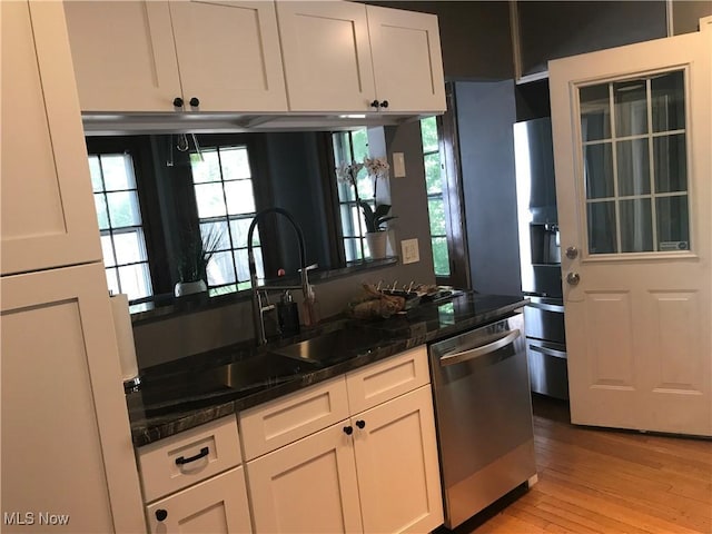 kitchen with white cabinetry, dark stone counters, light wood-style flooring, dishwasher, and refrigerator with ice dispenser