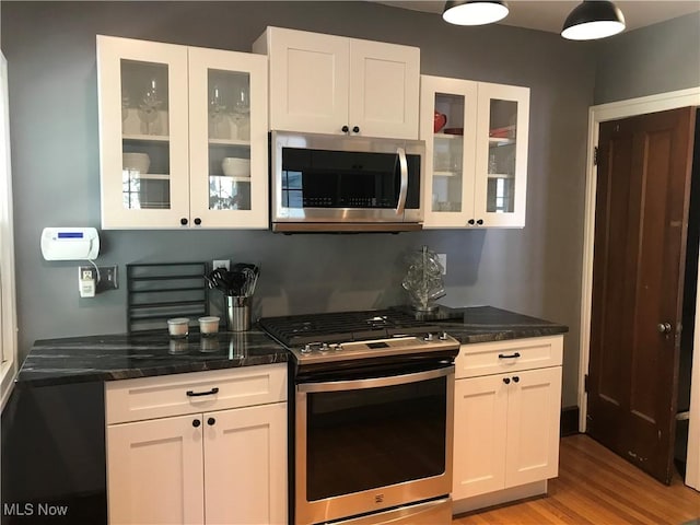 kitchen with white cabinets and appliances with stainless steel finishes