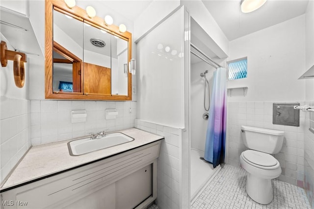 bathroom featuring tile patterned floors, tile walls, visible vents, and a stall shower