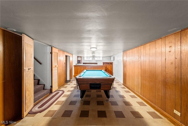 recreation room featuring pool table, wooden walls, and light floors