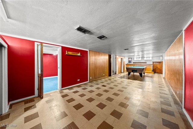 game room with visible vents, pool table, wood walls, a textured ceiling, and tile patterned floors