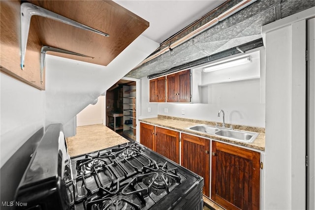 kitchen with light countertops, brown cabinetry, and a sink