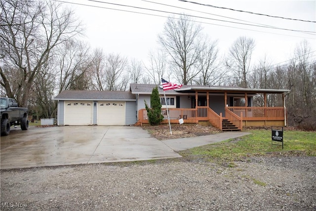 view of front of home with a garage, covered porch, and driveway