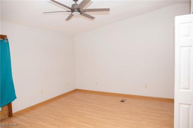 spare room with ceiling fan, baseboards, visible vents, and light wood-type flooring