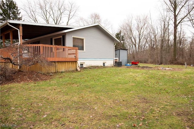 view of side of property featuring a wooden deck, crawl space, a yard, and cooling unit