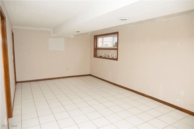 unfurnished room with baseboards