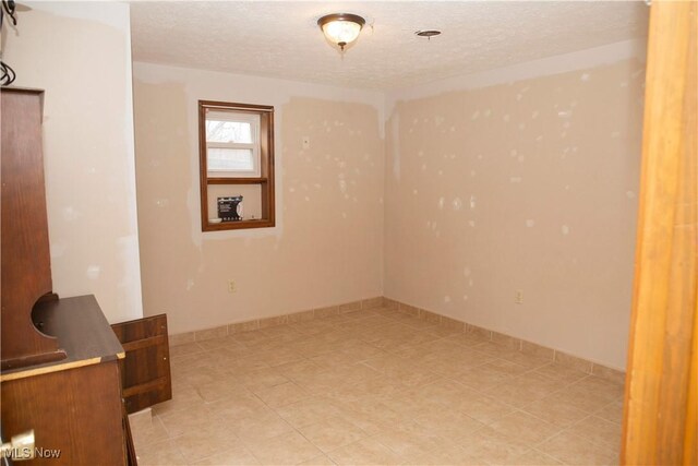 below grade area with a textured ceiling