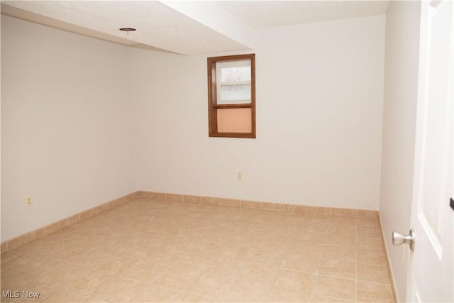 unfurnished room with light tile patterned floors