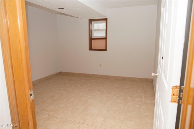 spare room featuring light tile patterned floors