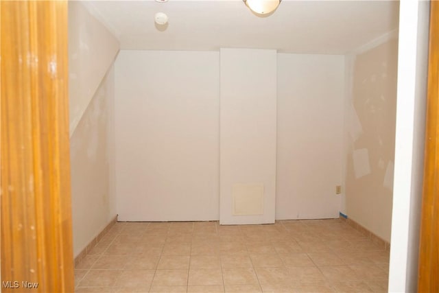 unfurnished room with light tile patterned flooring