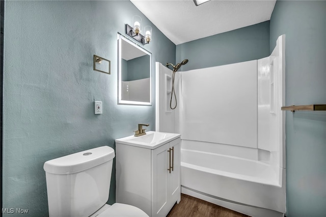 full bath with vanity, toilet, wood finished floors, and shower / washtub combination