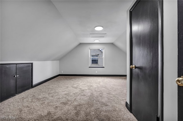 bonus room with baseboards, carpet, and vaulted ceiling