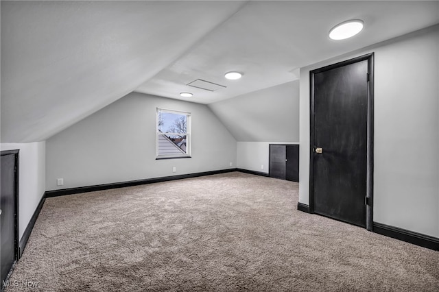 bonus room with carpet flooring, baseboards, and lofted ceiling