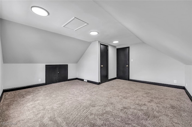 bonus room with baseboards, carpet, and lofted ceiling