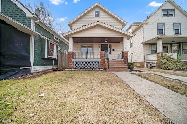 view of front of home featuring covered porch and a front lawn