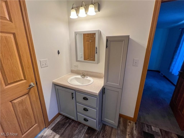 50055 Carroll Rd, East Liverpool, OH 43920 - bathroom featuring vanity, wood finished floors, and baseboards