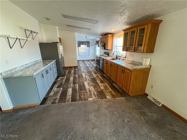 50055 Carroll Rd, East Liverpool, OH 43920 - kitchen with brown cabinetry, visible vents, stainless steel appliances, and light countertops