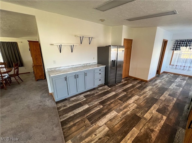 50055 Carroll Rd, East Liverpool, OH 43920 - kitchen with dark wood finished floors, open shelves, stainless steel fridge with ice dispenser, light countertops, and a textured ceiling