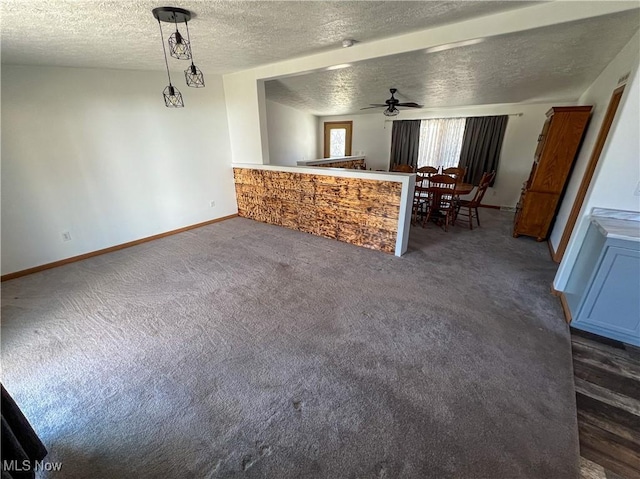 50055 Carroll Rd, East Liverpool, OH 43920 - unfurnished living room featuring dark carpet, a textured ceiling, baseboards, and ceiling fan