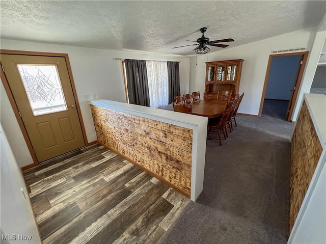 50055 Carroll Rd, East Liverpool, OH 43920 - dining room with visible vents, baseboards, a textured ceiling, a ceiling fan, and dark wood-style flooring