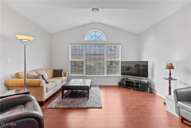 living room with lofted ceiling, wood finished floors, and baseboards