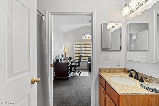 full bath with vanity, a shower with curtain, and vaulted ceiling