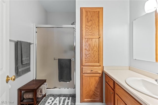 bathroom with vanity and a stall shower