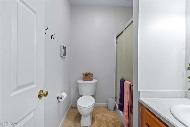 full bath with vanity, baseboards, tile patterned flooring, a shower stall, and toilet