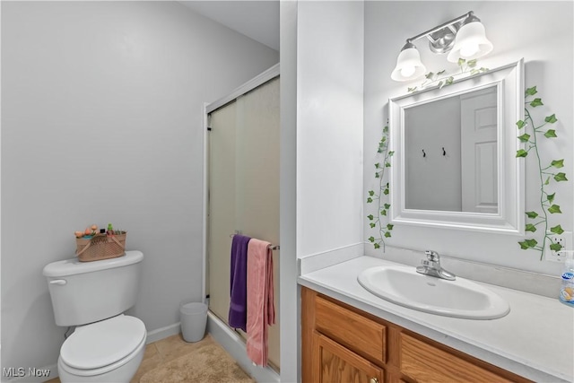 bathroom featuring toilet, a stall shower, vanity, and tile patterned flooring