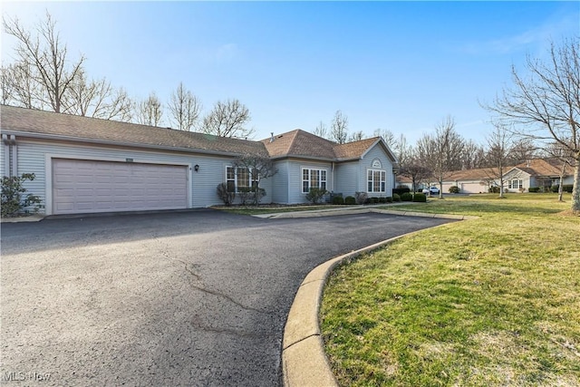 ranch-style house featuring a garage, a front lawn, and driveway